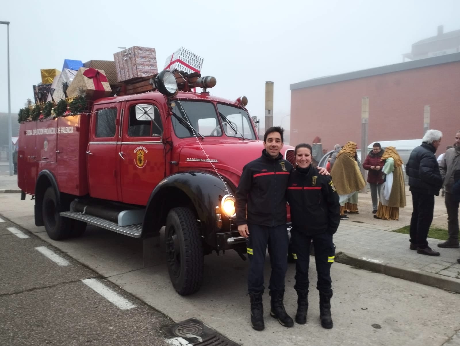 Inés aparece junto a su compañero Álvaro, ambos con traje de bomberos, en la Cabalgata de Reyes de este año antes de conducir el emblemático ”Abuelo”, un vehículo Autobomba Magirus de 1960.